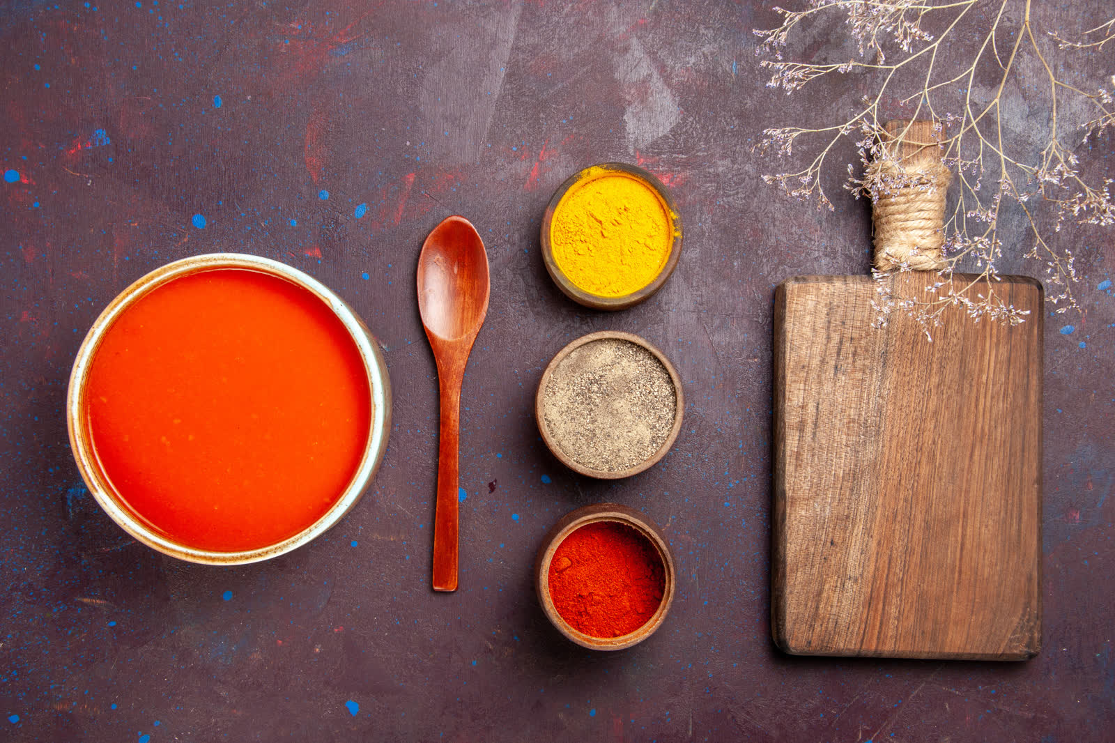 Top view delicious tomato soup cooked from fresh tomatoes with seasonings on dark background