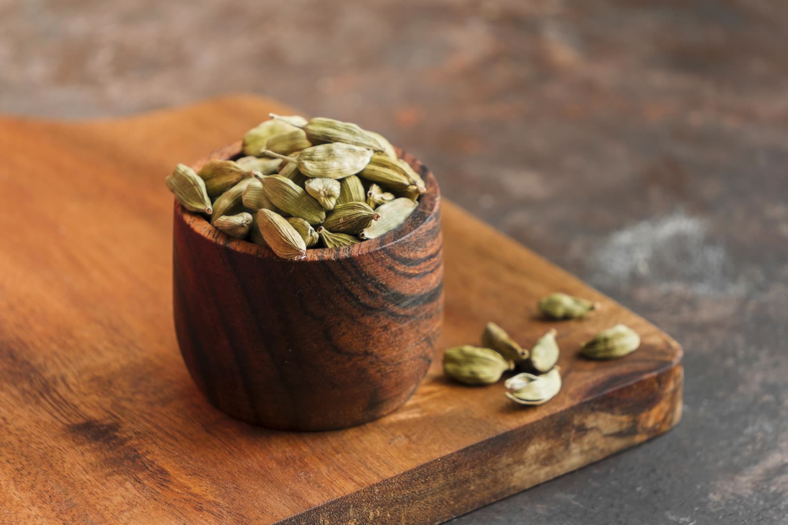 High angle cup with seeds (green cardamom pods)